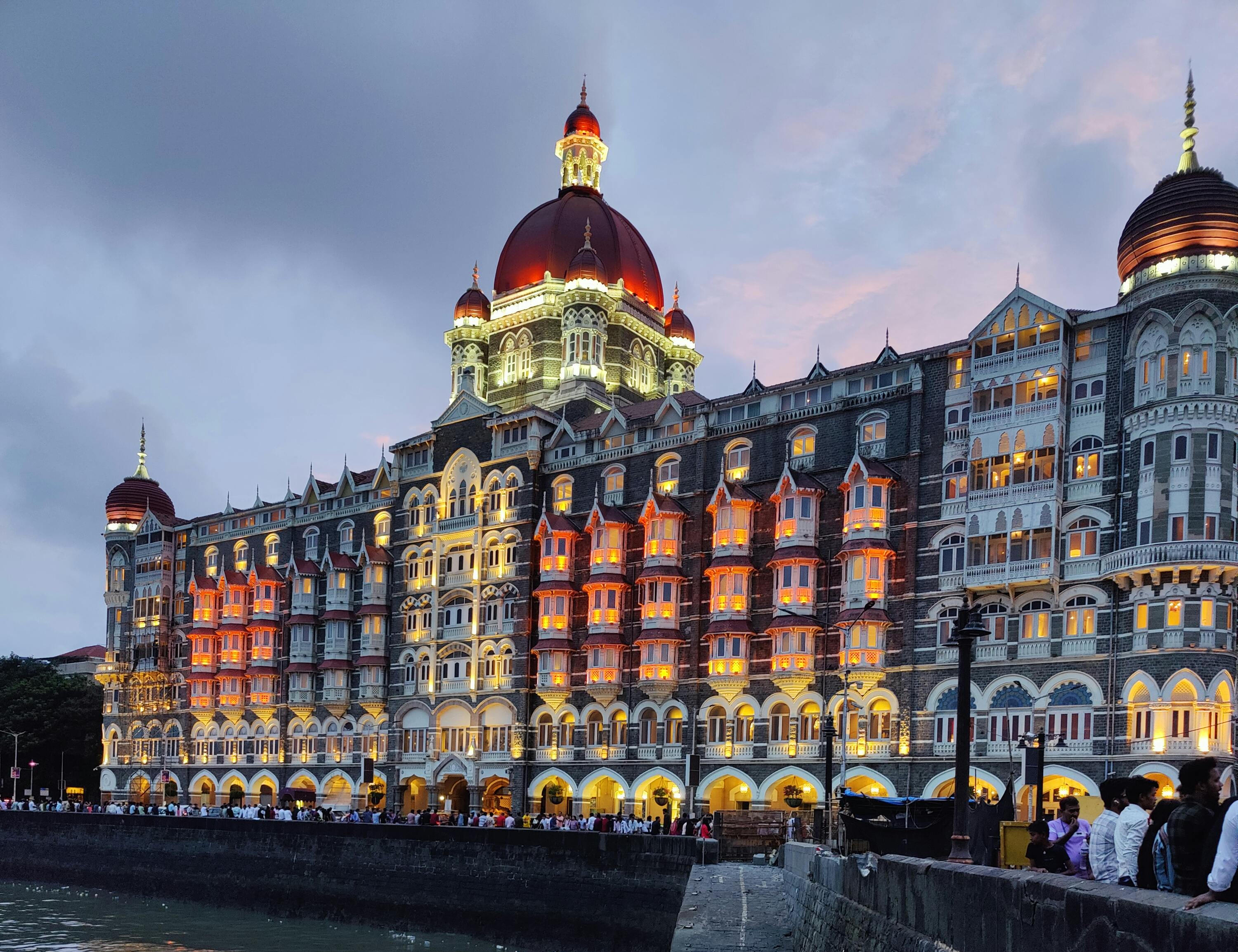 Taj Mahal Palace Hotel Mumbai with flock of birds in motion – Iconic Indian landmark and luxury hotel near Gateway of India | Apply for Indian eVisa online at Globally eVisas